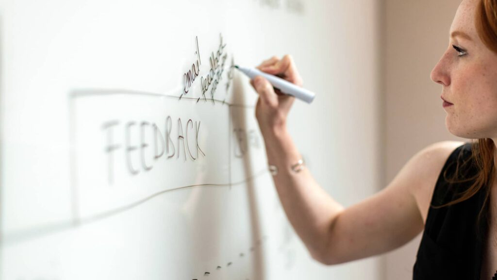 a person writing on a whiteboard