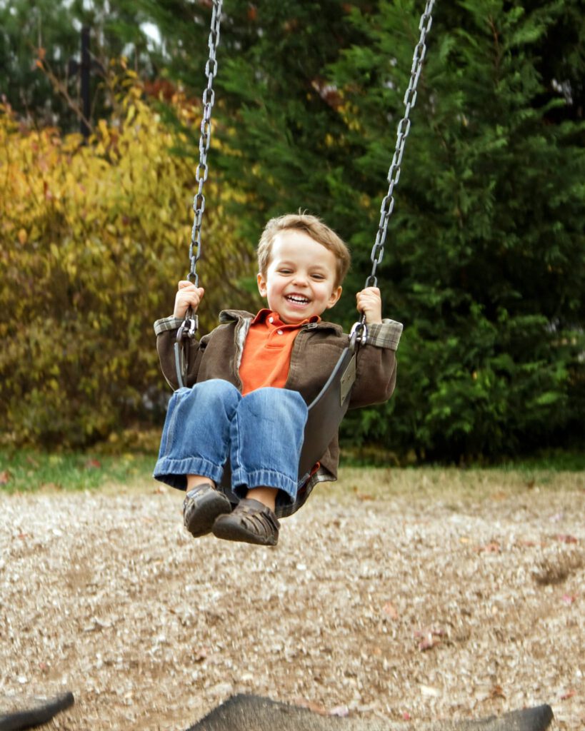 a happy boy on a swing